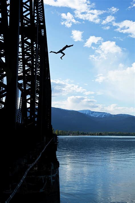 A Athletic Man Jumps Off A Train Bridge Photograph By Patrick Orton