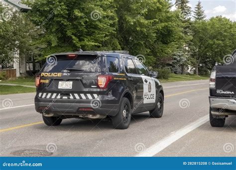 A Calgary Police Vehicle Car Driving On A Neighbourhood During The