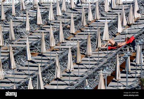 A Man Sunbathes On The Beach In Nice Southeastern France Tuesday