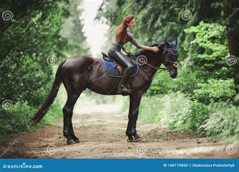 A Woman Riding On The Back Of A Horse