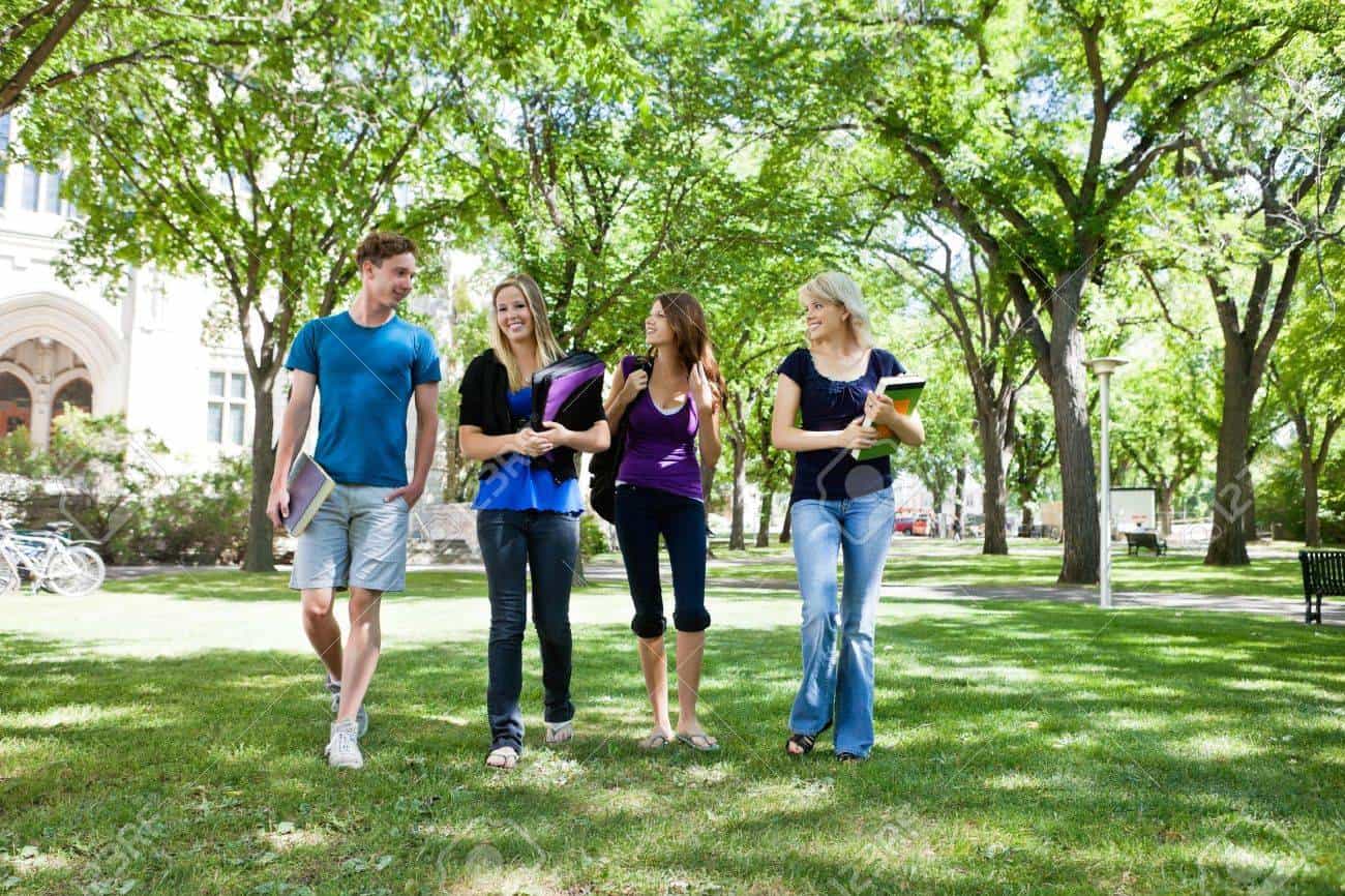 Diverse Group Of College Students Walking On Beautiful Campus Police