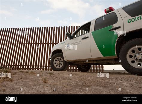 U S Border Patrol Vehicle Along The Border Wall Between The United