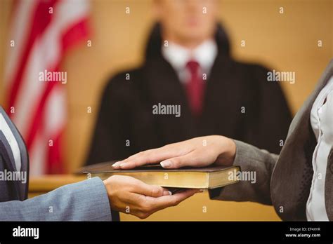 Witness Swearing On Bible Telling The Truth Stock Photo Download