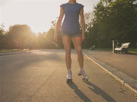 Woman Roller Skating At Sunset Stock Photo Download Image Now